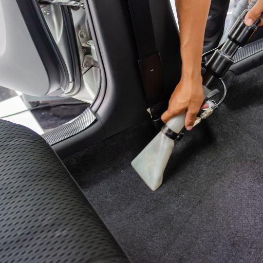 vacuuming and steam cleaning a car