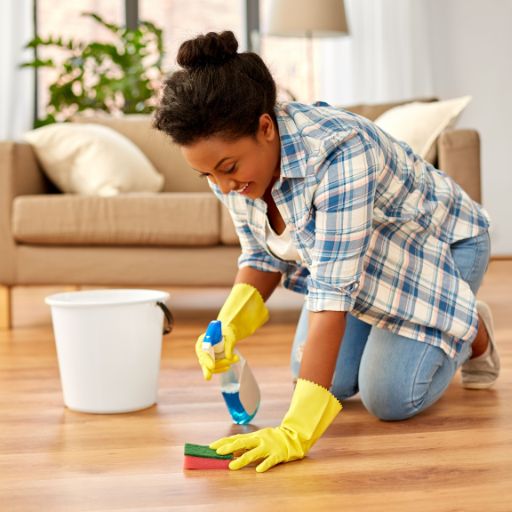 woman cleaning dirt off laminate floors